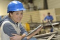 Woman in a metallurgic factory using tablet Royalty Free Stock Photo