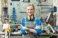 Woman metalworker with tool posing for the camera Royalty Free Stock Photo