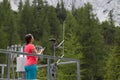 Woman meteorologist reading meteodata in mountain weather station