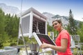 Woman meteorologist reading meteodata in mountain weather station