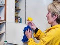 Woman with microfiber cleaning cupboard Royalty Free Stock Photo