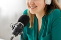 Woman with microphone recording podcast at studio Royalty Free Stock Photo