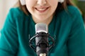 woman with microphone recording podcast at studio Royalty Free Stock Photo
