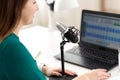 woman with microphone recording podcast at studio Royalty Free Stock Photo