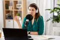 Woman with microphone recording podcast at studio Royalty Free Stock Photo