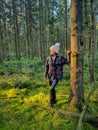 woman mid age walking in the forest during Autumn season in nature trekking with orange red color trees during fall Royalty Free Stock Photo