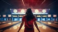 a woman in mid-throw as she releases the bowling ball down the lane, viewed from behind. The composition conveys the Royalty Free Stock Photo