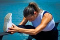 woman middle-aged fitness instructor doing training outdoor summer day city promenade river