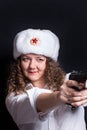 A woman in a military cap shoots a pistol. Royalty Free Stock Photo