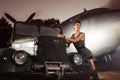 A woman in military clothes posing near a plane Royalty Free Stock Photo