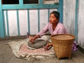 Woman milling corn in Thamchok village - Nepal