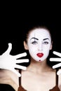 Woman mime with hands in white gloves