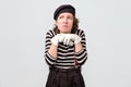 Woman mime looks with doubt upwards being deep in thoughts Royalty Free Stock Photo