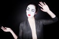 Woman in mime make-up dancing