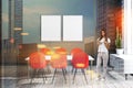 Woman in gray dining room with posters Royalty Free Stock Photo