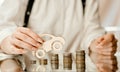 Woman on a mirrored table on a roller coaster of coins leads a machine of wood up Royalty Free Stock Photo