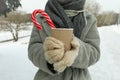 Woman in mittens hold cup of hot drink outdoor in winter Royalty Free Stock Photo