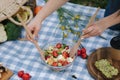 Woman mix vegan salad on picnic outside. Vegan food concept Royalty Free Stock Photo