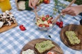 Woman mix vegan salad on picnic outside. Vegan food concept Royalty Free Stock Photo