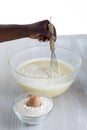 Woman mixing cake ingredients in a mixing bowl