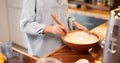 Woman mixing daugh for baking waffles at home