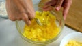 Woman mixing egg, spices with boiled mashed potatoes cooking draniki, pancakes.