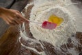 Woman mixing flour and egg with a batter spatula