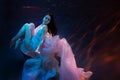 Woman model, ballerina underwater in a fluttering dress.