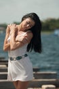 Woman model at the beach in bright sunlight.