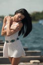 Woman model at the beach in bright sunlight.