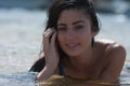 Woman model at the beach in bright sunlight.