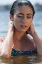 Woman model at the beach in bright sunlight.