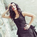 Woman, model of fashion, wearing black dress with curly hair