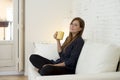 Woman at modern apartment living room home couch enjoying coffee tea cup Royalty Free Stock Photo