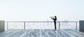 A woman on a balcony uses a telescope to explore the sprawling urban landscape before her Royalty Free Stock Photo