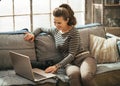 Woman with modern dslr photo camera using laptop Royalty Free Stock Photo