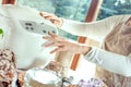 Woman in a modern kitchen sets a machine for baking