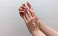 Woman moisturizing her hand with cosmetic cream.