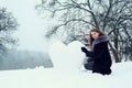 Woman molds a heart of the snow Royalty Free Stock Photo