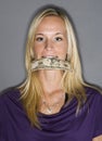 Woman with money in her mouth