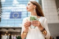 Woman with money near the parliament building in Brussel Royalty Free Stock Photo