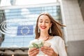 Woman with money near the parliament building in Brussel Royalty Free Stock Photo