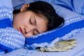 Woman with money under her pillow