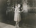 Woman monitoring sound in 1930s recording studio