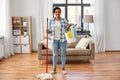 Woman with mop and other cleaning stuff at home Royalty Free Stock Photo