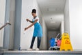 Woman Mopping Corridor