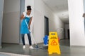 Woman Mopping Corridor