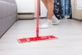 Woman mopping the floor in a living room Royalty Free Stock Photo