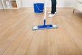 Woman mopping hardwood floor at home Royalty Free Stock Photo