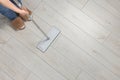 Woman mopping wooden floor, top view. Space for text